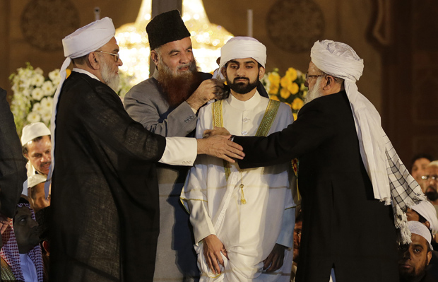 Syed Ahmed Bukhari, left, Shahi Imam of Delhi's Jama Masjid, and other Muslim clerics tie a turban on the head of Syed Shaban Bukhari, center, during his anointment ceremony as deputy Imam, at Jama Masjid in New Delhi (Photo: AP) Syed Ahmed Bukhari, left, Shahi Imam of Delhi's Jama Masjid, and other Muslim clerics tie a turban on the head of Syed Shaban Bukhari, center, during his anointment ceremony as deputy Imam, at Jama Masjid in New Delhi (Photo: AP)